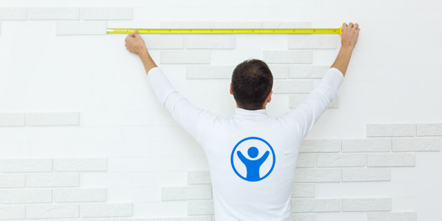 A man measuring the gap with a tape measure